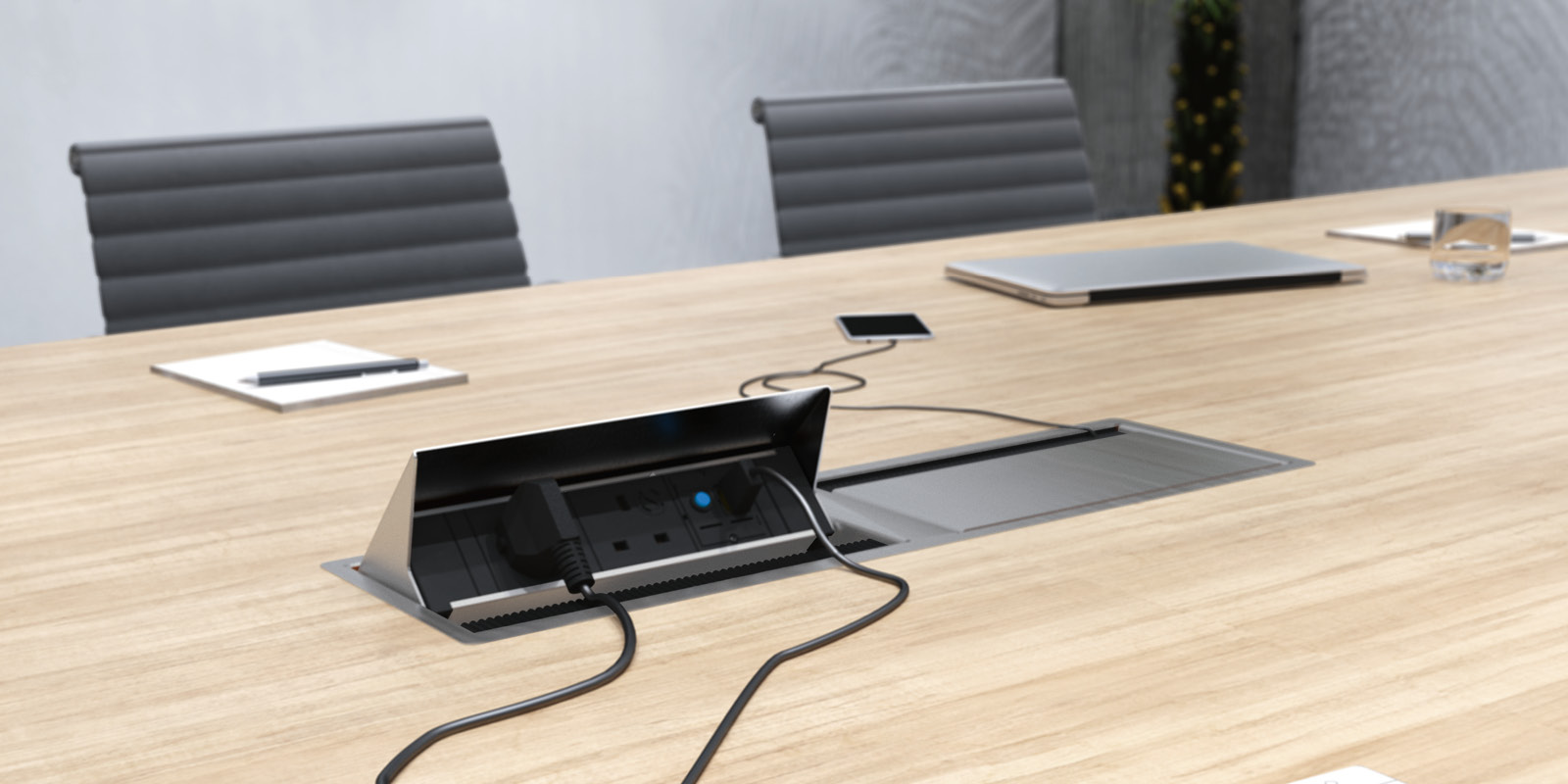 Coni Duo power and data outlet mounted on desk with one side open and the other closed close-up