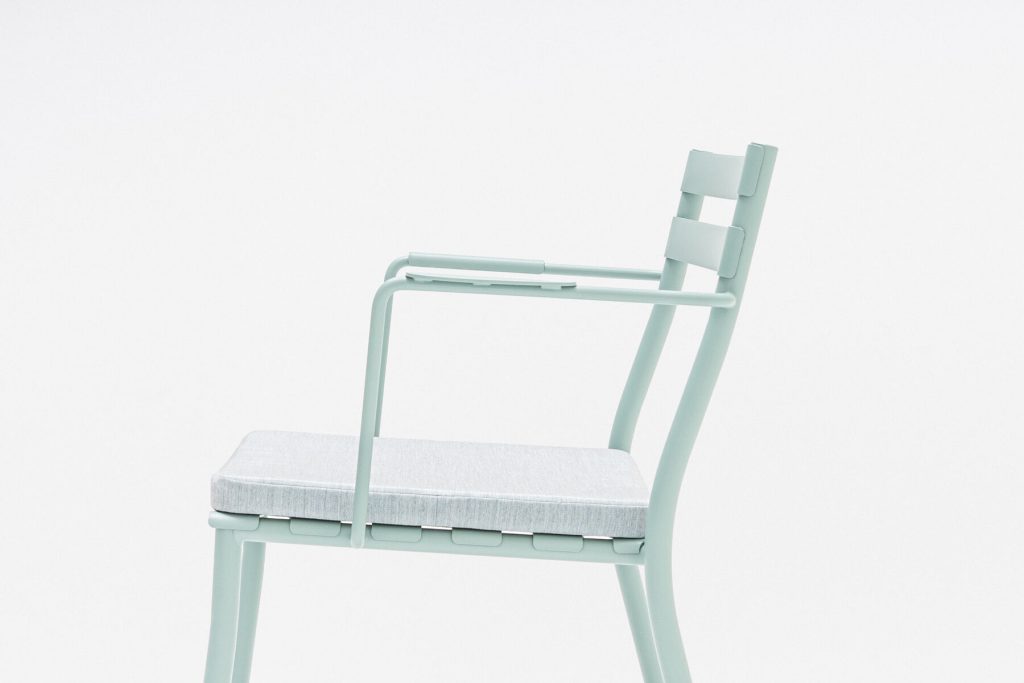 outdoor flaner armchair in light grey with a grey pillow