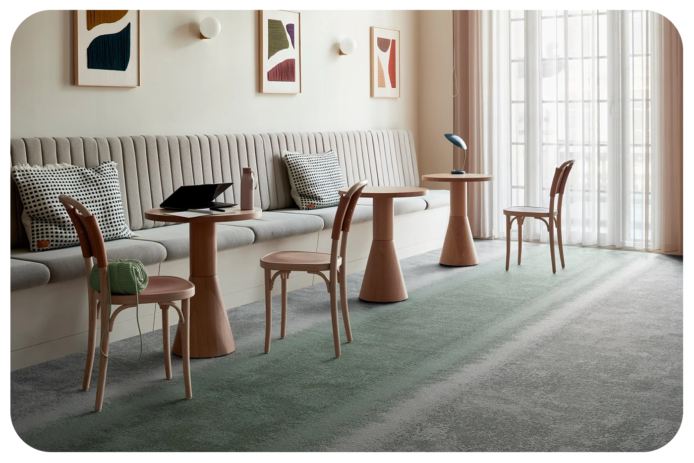 lounge area with soft seating and modular flooring in two colors. One in the lounge are and one in the rest of the room