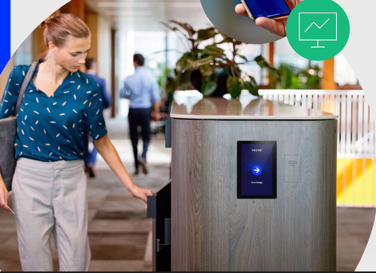 a woman is opening a locker with Vecos system in an open plan space