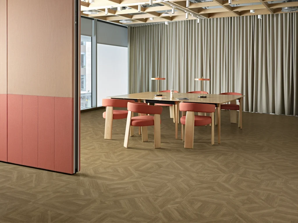 contemporary meeting room with lvt flooring in harvest color and wood and orange chairs